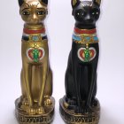 Ornate gold and black cat figurines with Egyptian-inspired design