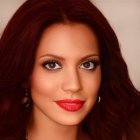 Woman with Deep Red Curly Hair and Piercing Brown Eyes wearing Gold Earrings