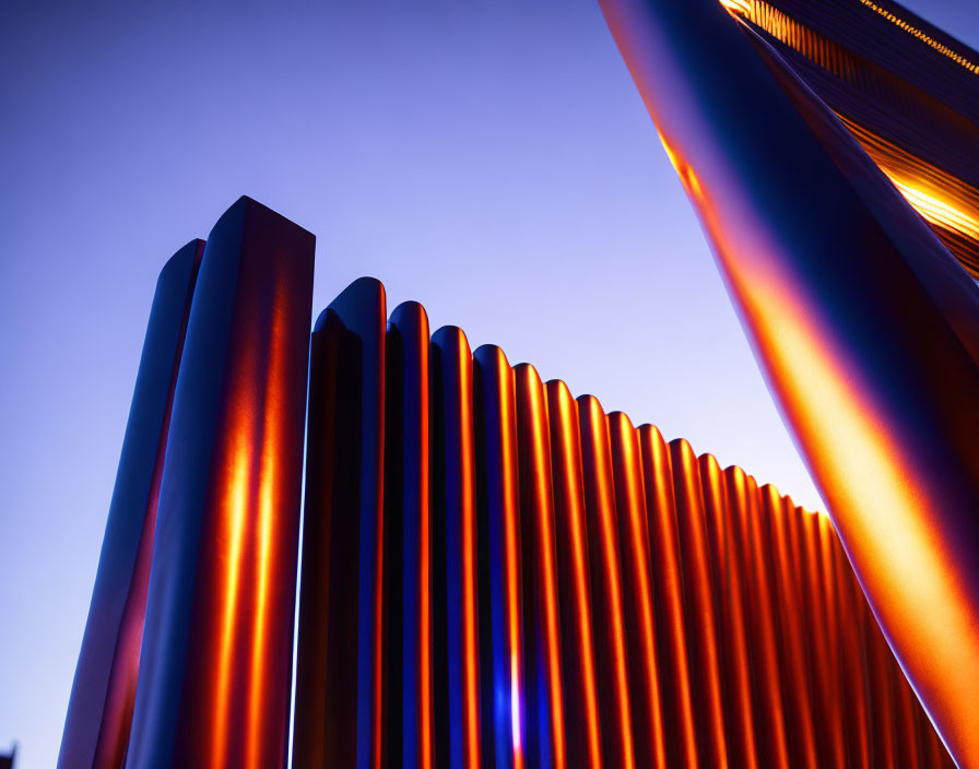 Architectural fins on building facade under gradient twilight sky