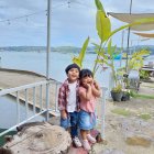 Girl with Long Hair in Colorful Outfit at Vibrant Seaside Village