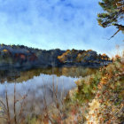 Tranquil lake with autumn forest and clear blue sky