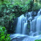 Tranquil landscape with cascading waterfall and lush greenery