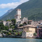 Medieval village with stone houses, castle, lake, mountains