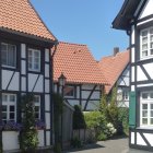 Picturesque European Street with Half-Timbered Houses and Colorful Flowers