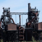 Overgrown futuristic ruins with tall industrial towers in dense foliage