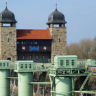 Fairytale castle with spires, cherry trees, bridges, and blue skies