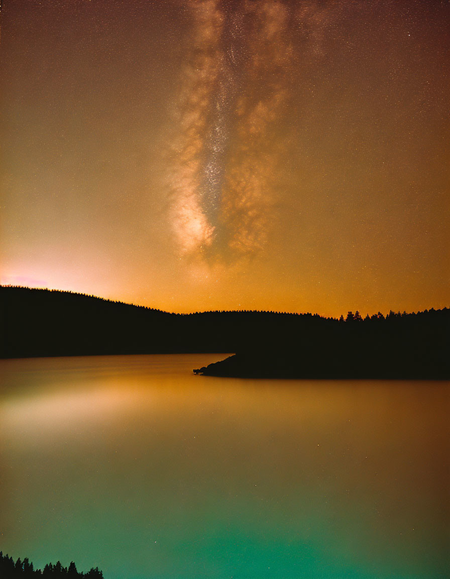 Tranquil night landscape: starry sky, Milky Way, calm lake, forested hills