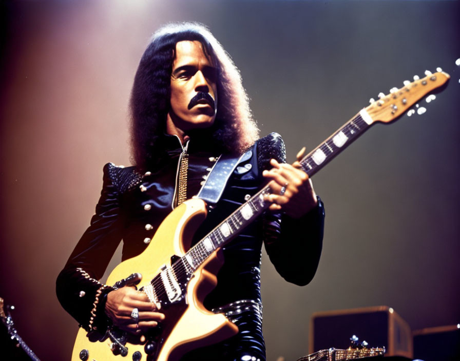 Musician with Afro Hairstyle Playing Electric Guitar in Shiny Black Outfit