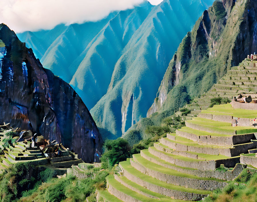 Machu Picchu: Terraced slopes and towering green peaks with tourists among ancient Incan ruins