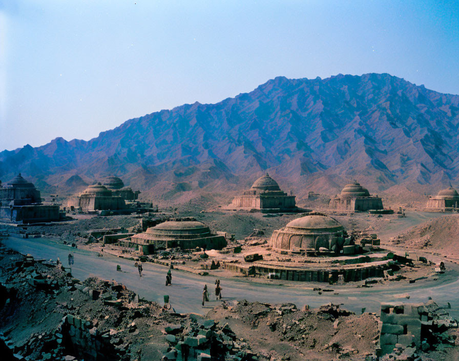 Desert ruins with domed structures in rocky mountains