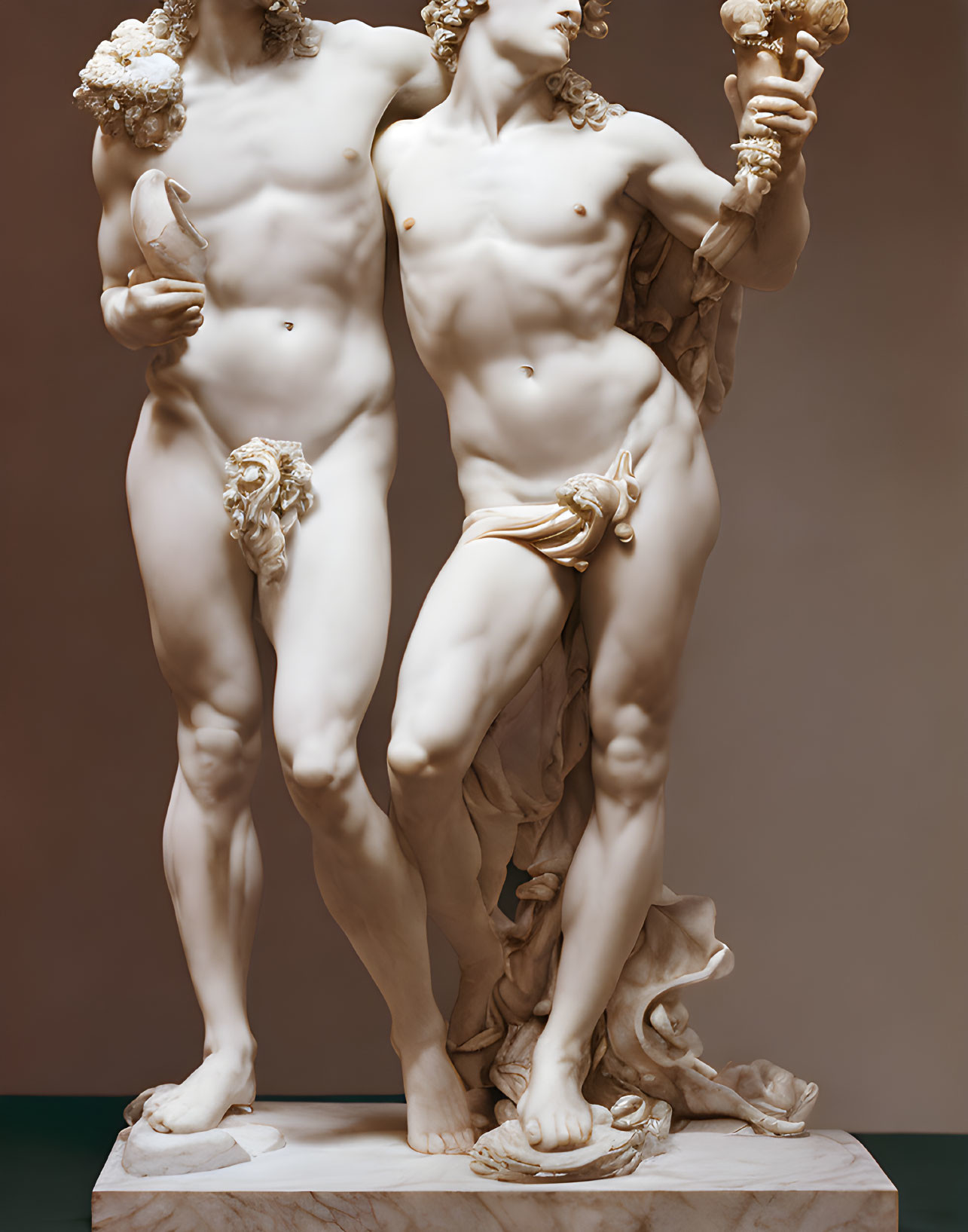Marble sculpture of two nude figures with detailed musculature and draped cloth.