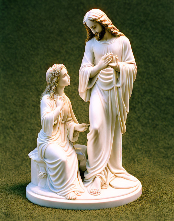 Religious statue of Jesus Christ blessing a kneeling woman