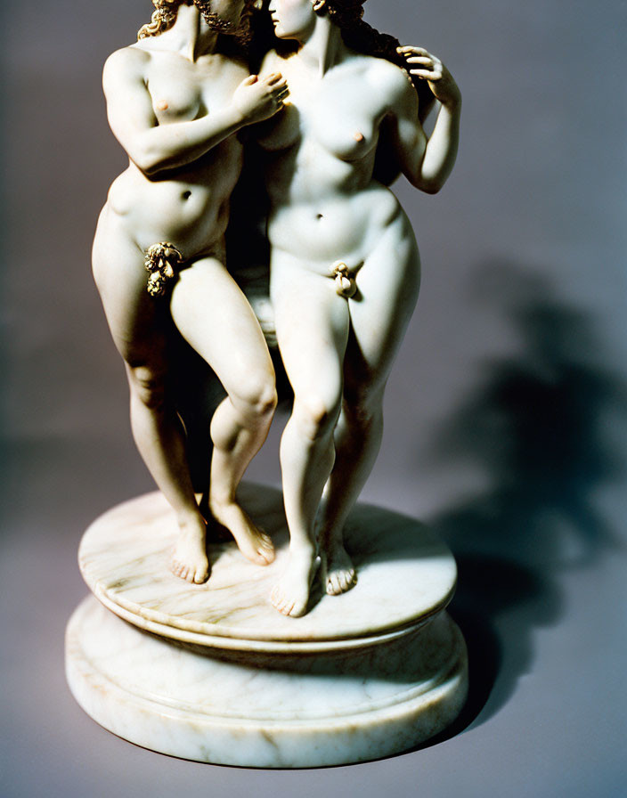 Marble sculpture of intertwined female figures on round base