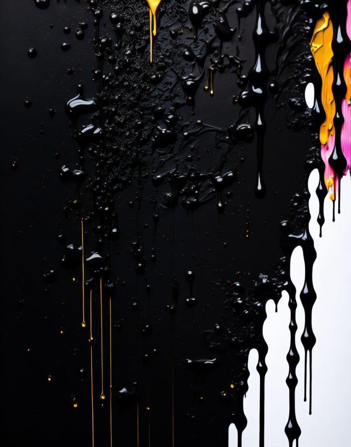 Abstract yellow and pink paint streaks on glossy black surface