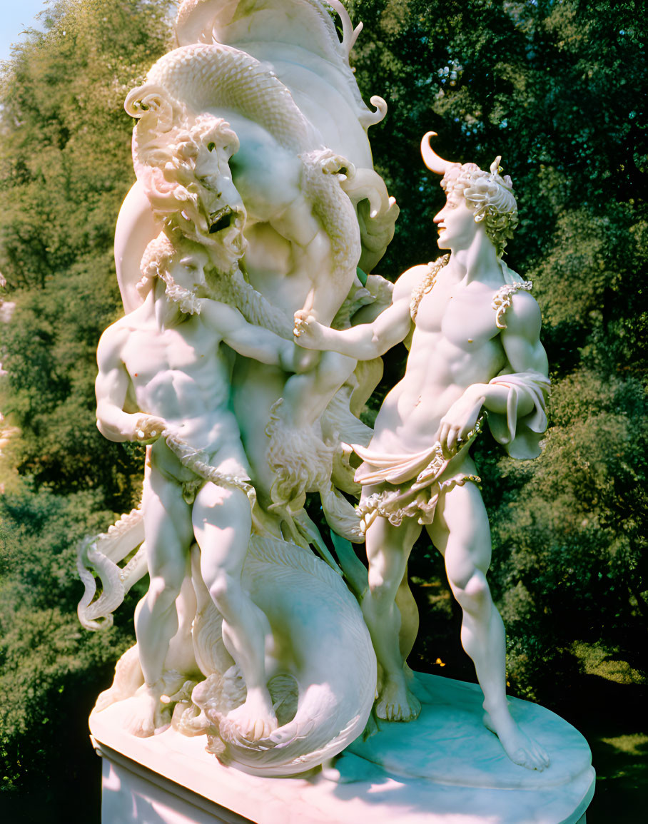 Classical-style sculpture of nude figures with sea creature in lush green setting