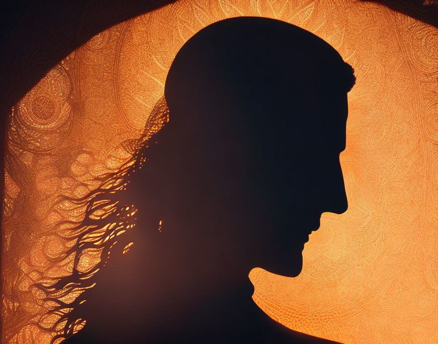 Profile silhouette against ornate orange pattern - artistic and mysterious