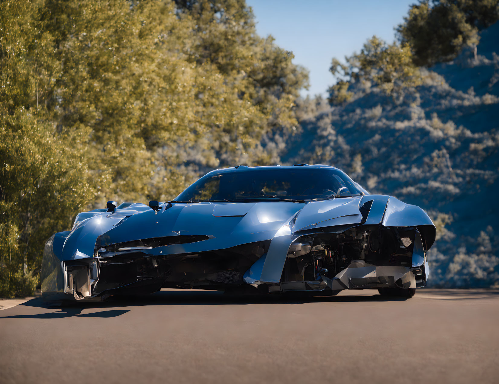 Blue sports car on asphalt road with green trees and clear sky