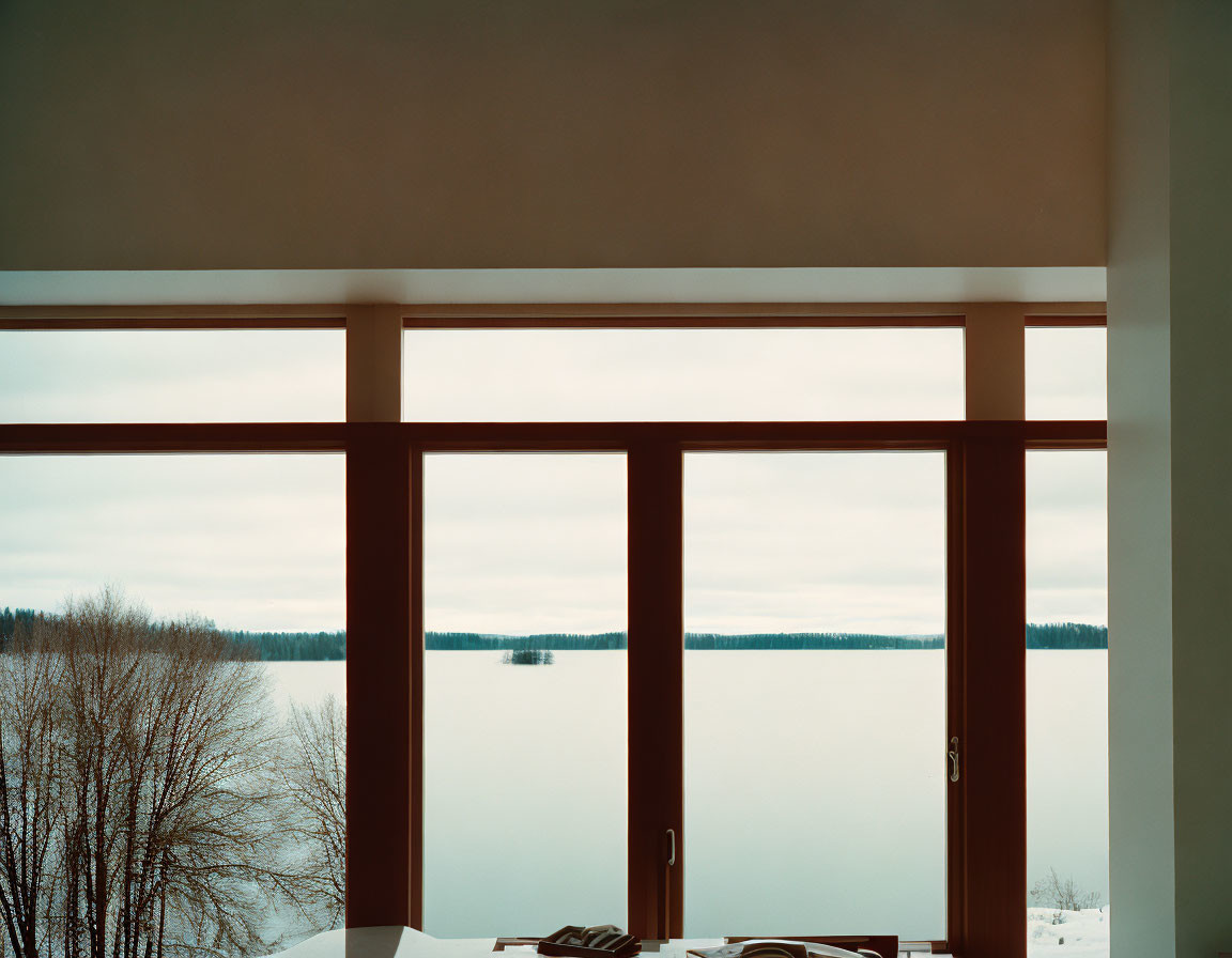 Room with Large Windows Showing Snowy Landscape