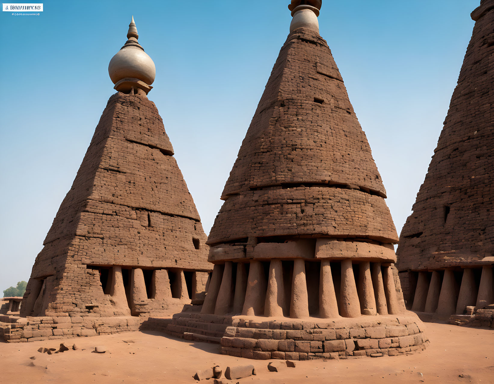 Sudanese-style Mosques with Conical Towers and Wooden Beams against Clear Blue Skies