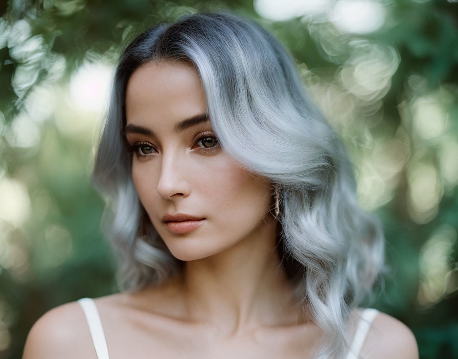 Ombre Hair Woman with Waves and Subtle Gaze in Green Foliage