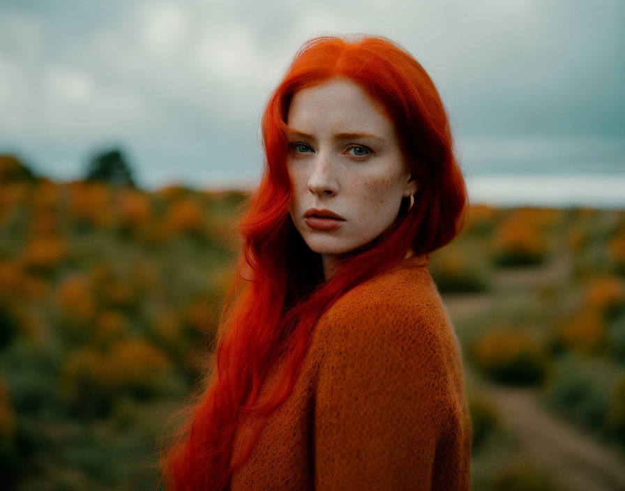 Red-haired woman in rust sweater amid autumn scenery