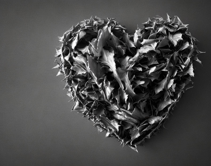 Textured heart shape made of spiky fragments on dark background