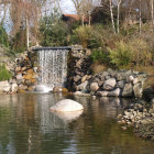 Tranquil scenery of small waterfall in lush, green landscape