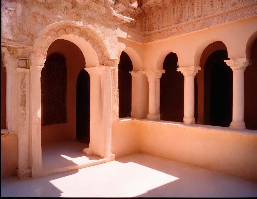 Traditional Architecture: Sunlit Courtyard with Ornate Archways and Wall Carvings