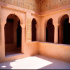 Traditional Architecture: Sunlit Courtyard with Ornate Archways and Wall Carvings