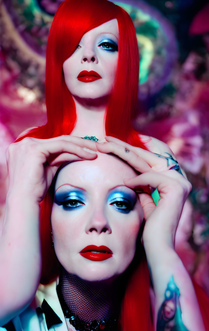 Vibrant red hair and bold blue eye makeup in mirrored poses in floral setting