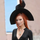 Red-Haired Person in Black Hat and V-Neck Shirt with Round Necklace