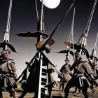 Elongated helmeted armored figures under a large moon in a surreal desert landscape