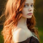 Vibrant red-haired woman in fantasy makeup and gothic armor with ornate headpiece