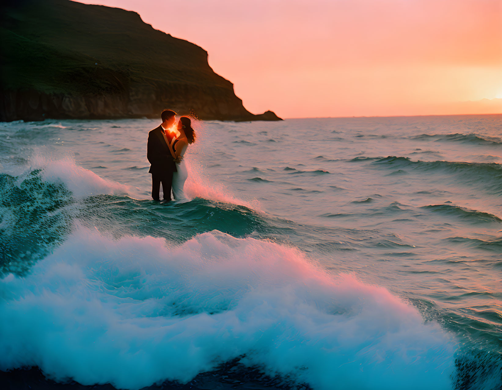 Romantic couple embracing on beach at sunset with crashing waves