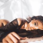 Woman Sleeping Peacefully in Fur Blanket with Falling Snow and White Flower