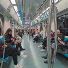 Passengers in vintage attire on ornate, fantastical train carriage