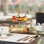 Elegant Afternoon Tea Set with Tiered Cake Stand and Pink Flowers