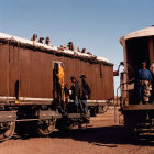 Rust-Colored Train with Three Individuals under Clear Sky