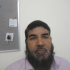 Bearded man with glasses gazes upward in office setting