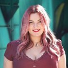 Red-Haired Woman Smiling by Turquoise Water