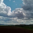 Dramatic Sky Over Serene Landscape and Fields