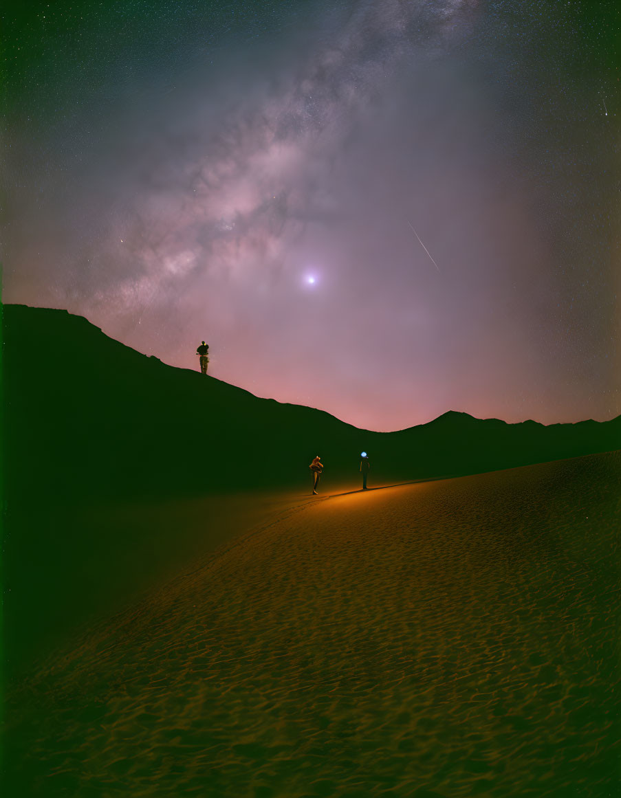 Desert night sky with starry backdrop and tower silhouette.