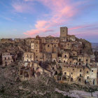 Traditional houses in lush landscape with hazy sunrise and distant city skyline