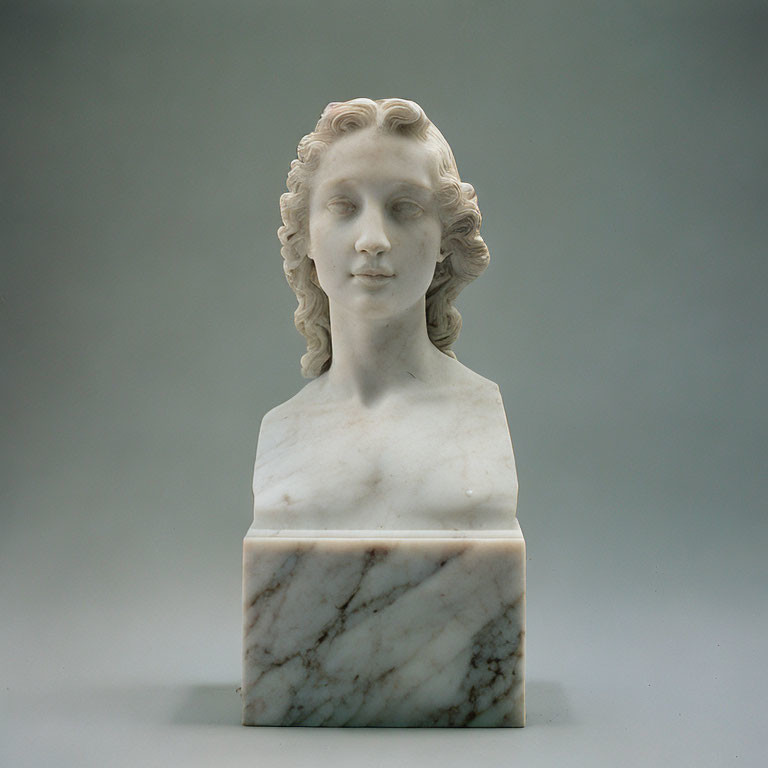 Marble bust of woman with wavy hair on square base