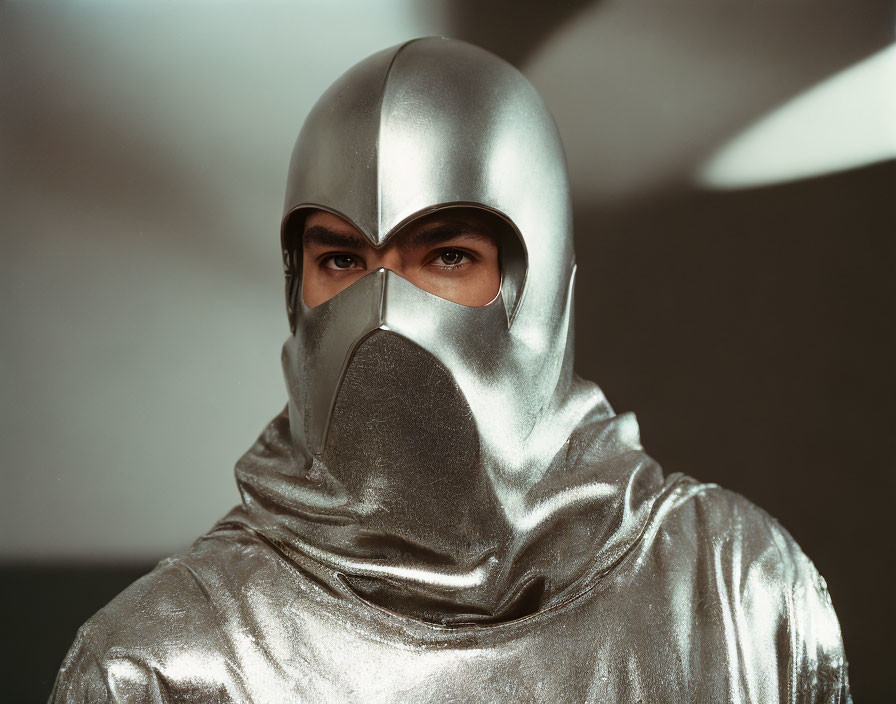 Shiny silver futuristic knight helmet and garment with eye opening