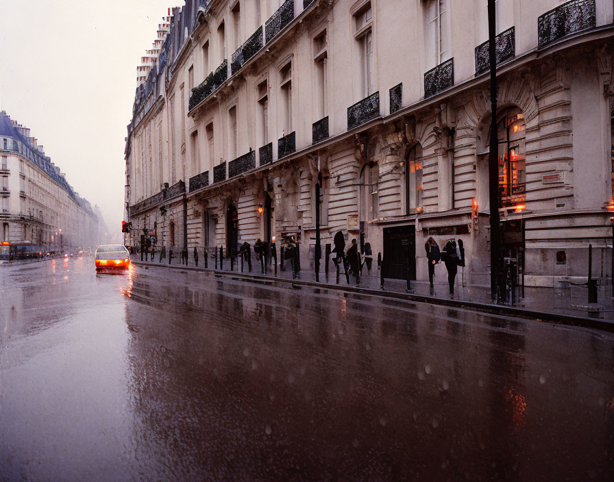 City street scene with pedestrians, umbrellas, cars, and snow reflections