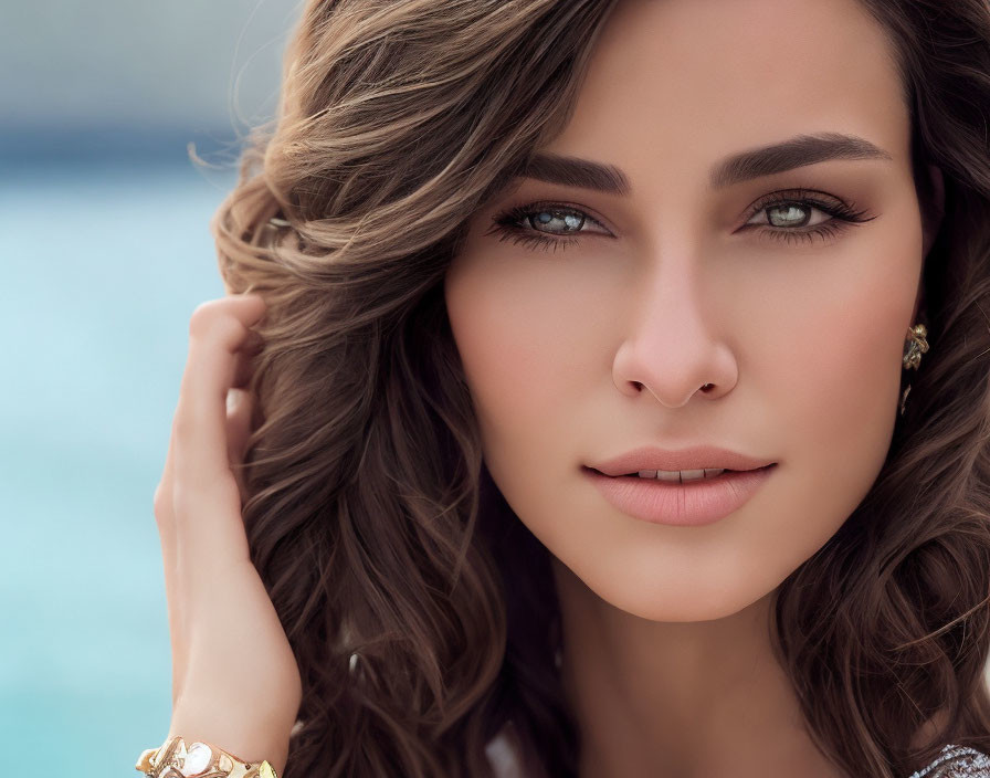 Portrait of Woman with Wavy Brown Hair and Nose Ring on Blue Background