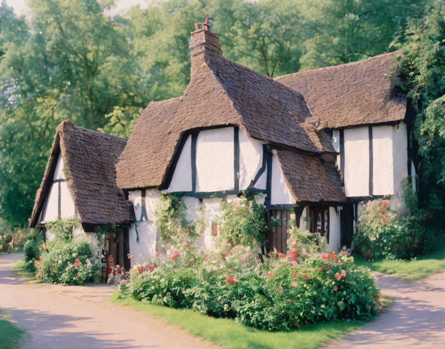 Thatched-Roof Cottage Surrounded by Greenery and Flowers