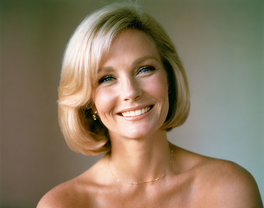 Blond woman with necklace and earrings on soft-focus background