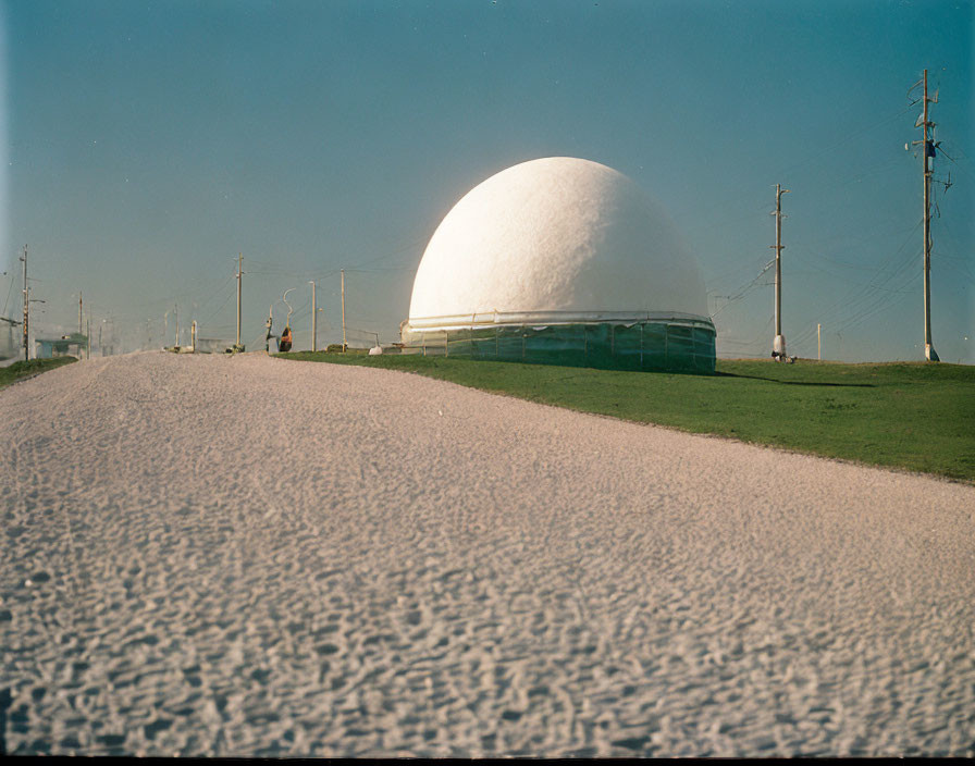 White Textured Spherical Dome Structure in Open Grass Field